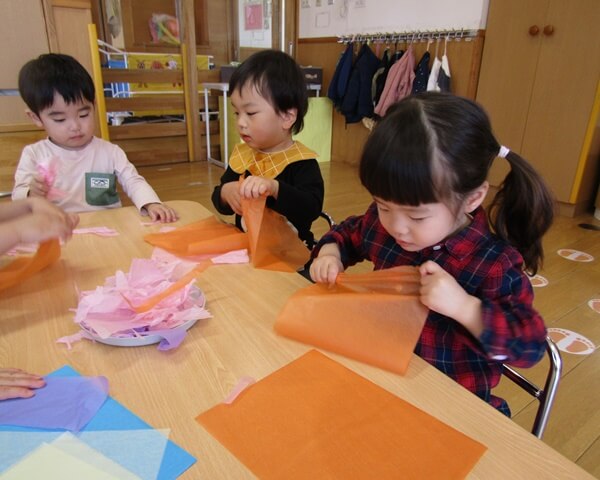 紙を使って何かを作る子ども